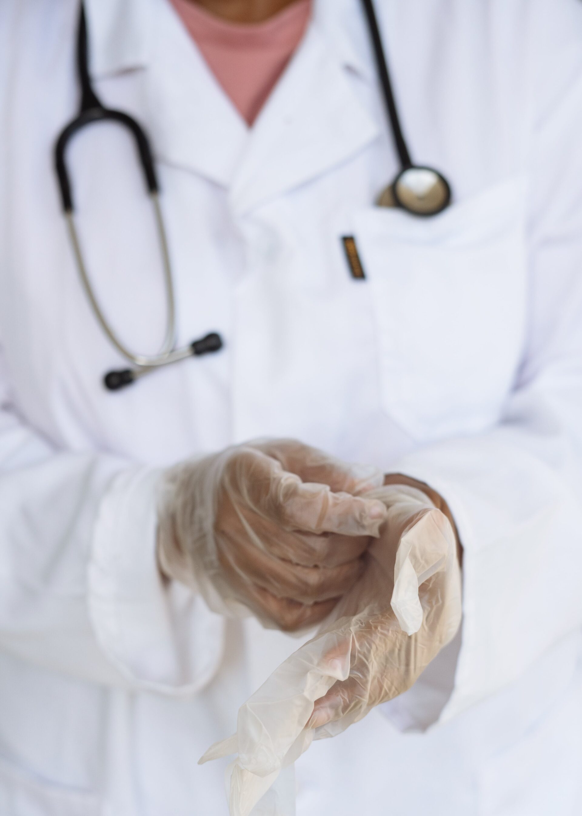 A nurse preparing for a procedure, focused on wearing sterile gloves for patient safety.