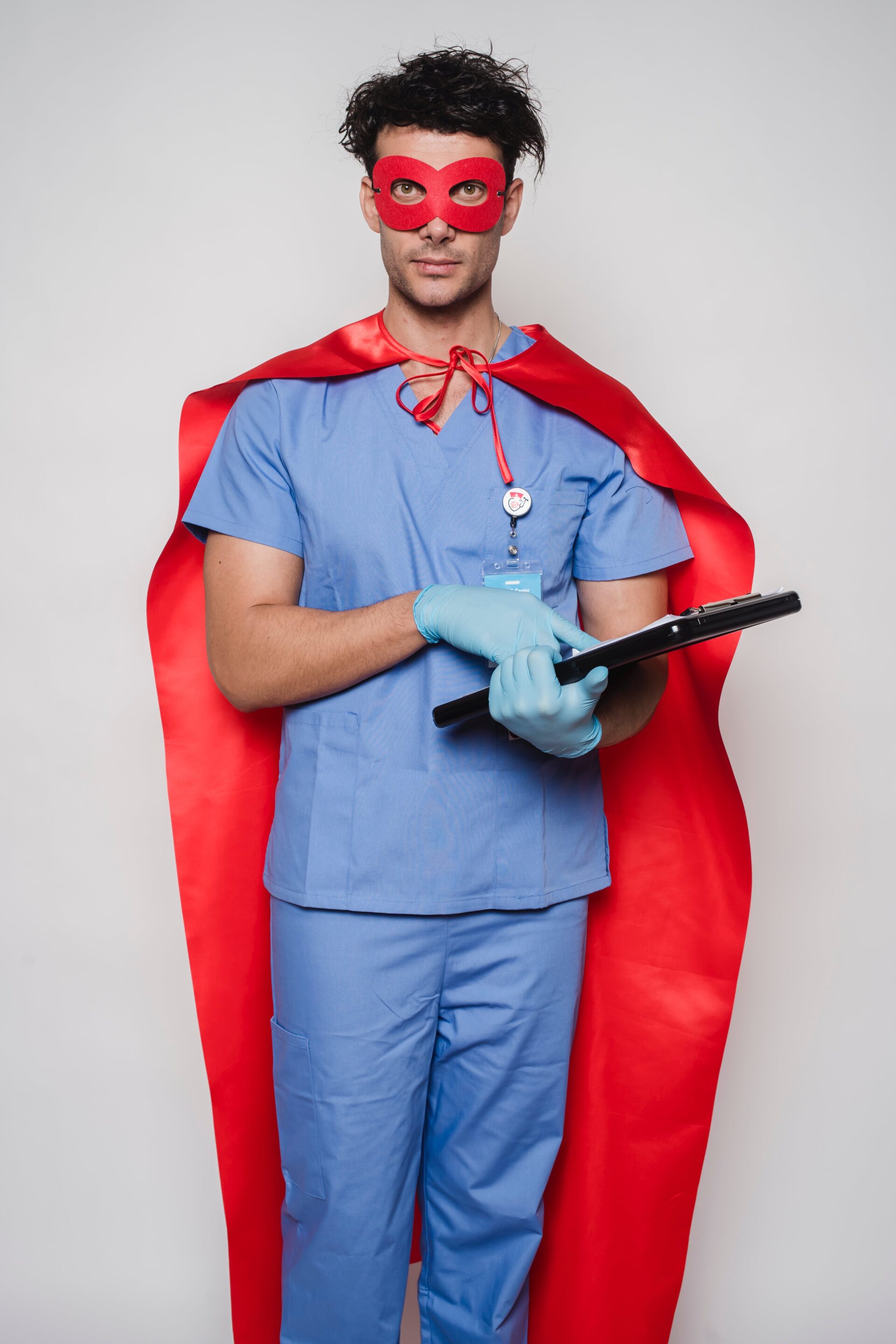 A confident healthcare hero, a medical worker dressed in scrubs with a red cape and mask, symbolizing the heroic efforts of nurses and healthcare staff.