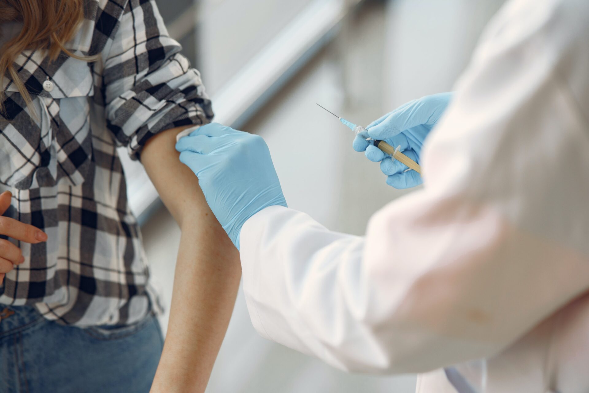 A healthcare professional administering a vaccine to a patient's arm, depicting a common nursing practice.