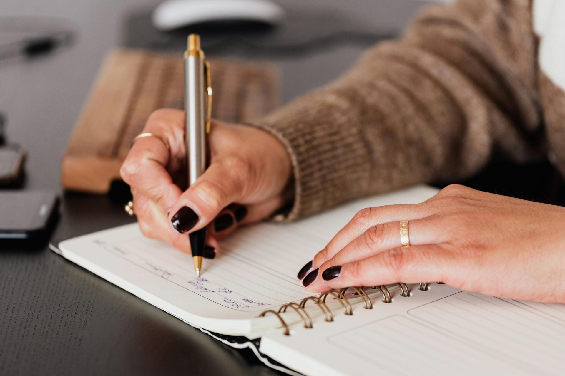 Close-up of a nurse writing notes in a journal, representing strategies for Nurse Essay Writing.