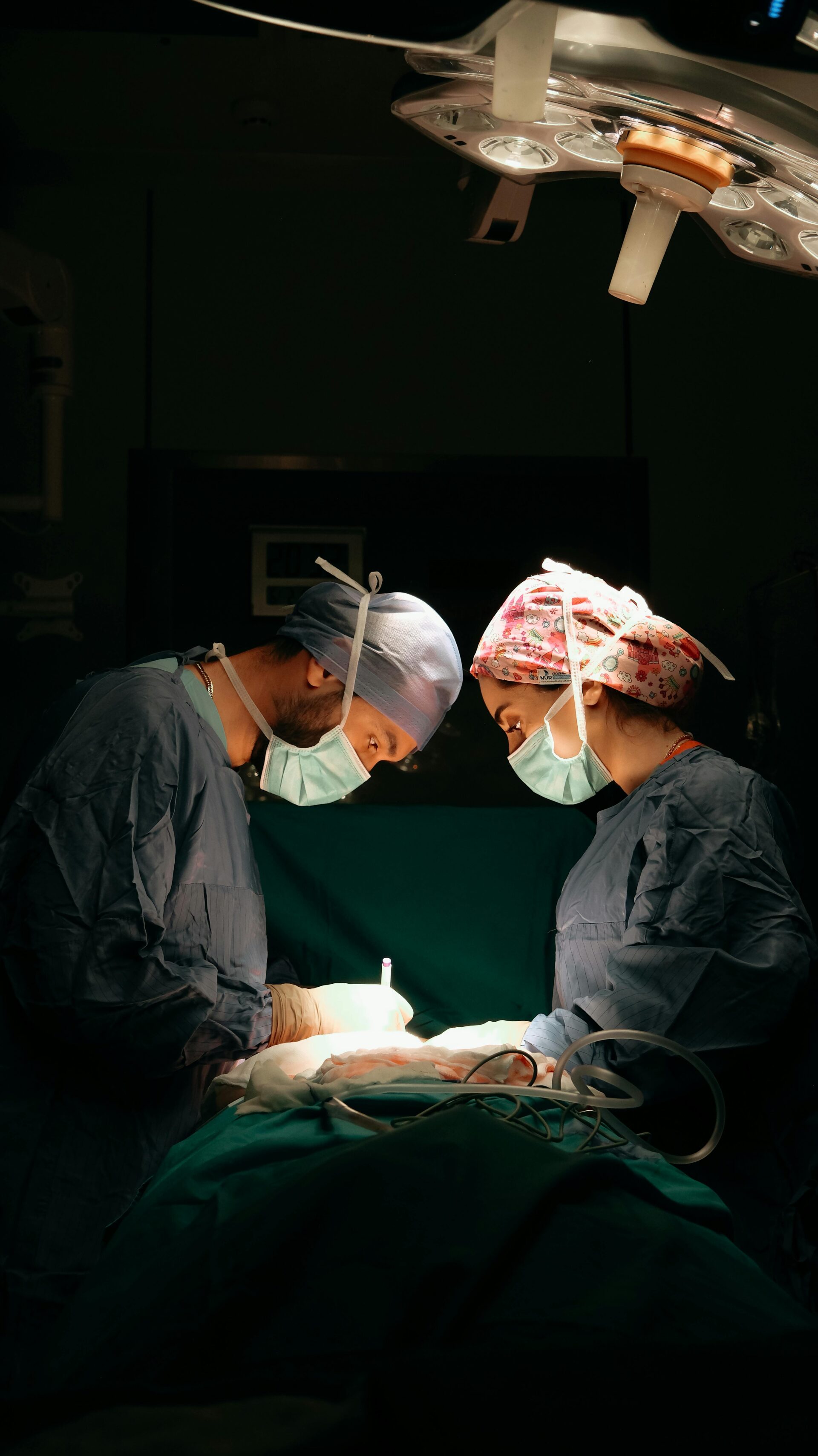 Nurses performing surgery on a patient in an operating theater, highlighting the importance of nursing papers in academic writing.